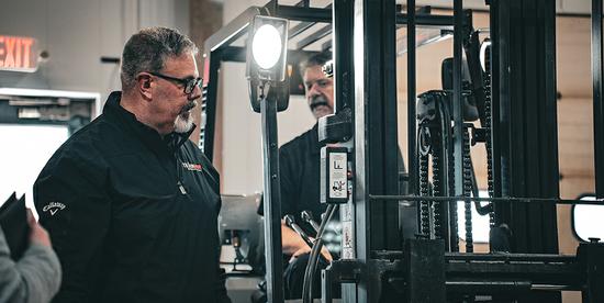 Trainer Scott looking at a forklift mast